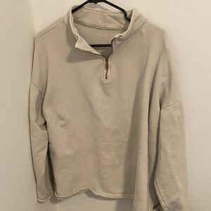 Gillian Steven’s Beige Zip-Up Sweater